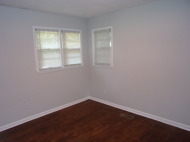 3231 State Line Road Taft, TN 38488 - Photo 15 of 26 an empty room with wooden floor and windows