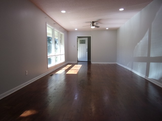 3231 State Line Road Taft, TN 38488 - Photo 3 of 26 an empty room with wooden floor and windows