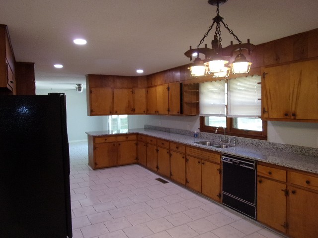 3231 State Line Road Taft, TN 38488 - Photo 4 of 26 a large kitchen with a chandelier stainless steel appliances and a counter top space