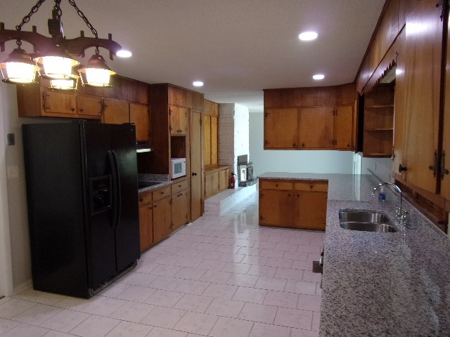 3231 State Line Road Taft, TN 38488 - Photo 5 of 26 a kitchen with stainless steel appliances a refrigerator and a stove