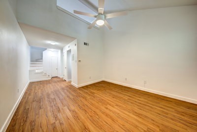 wooden floor in an empty room with a window