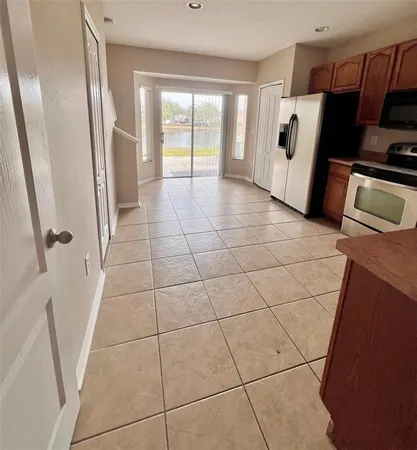 a view of a refrigerator and window in a room