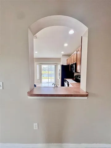 a view of a living room with kitchen furniture and a fireplace