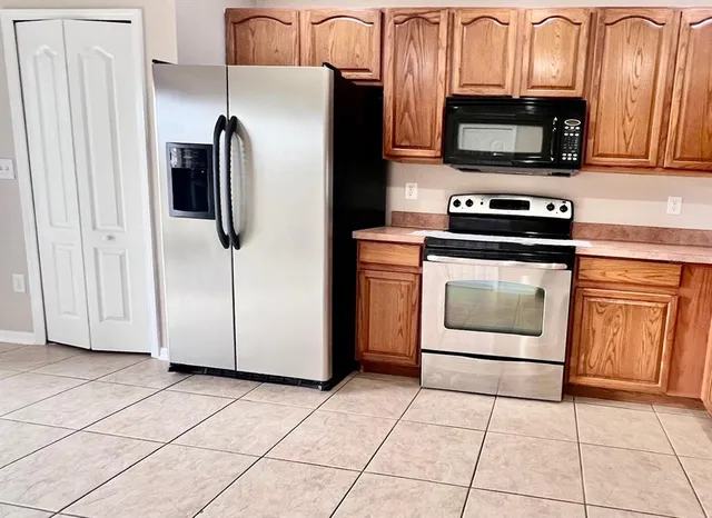 a kitchen with stainless steel appliances a stove a microwave and a refrigerator