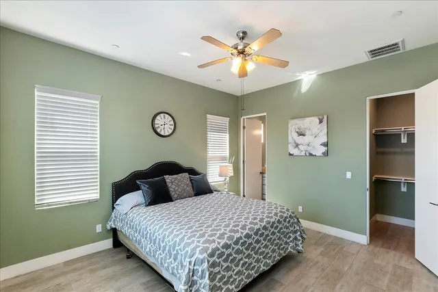 a bedroom with a bed and painting on the wall