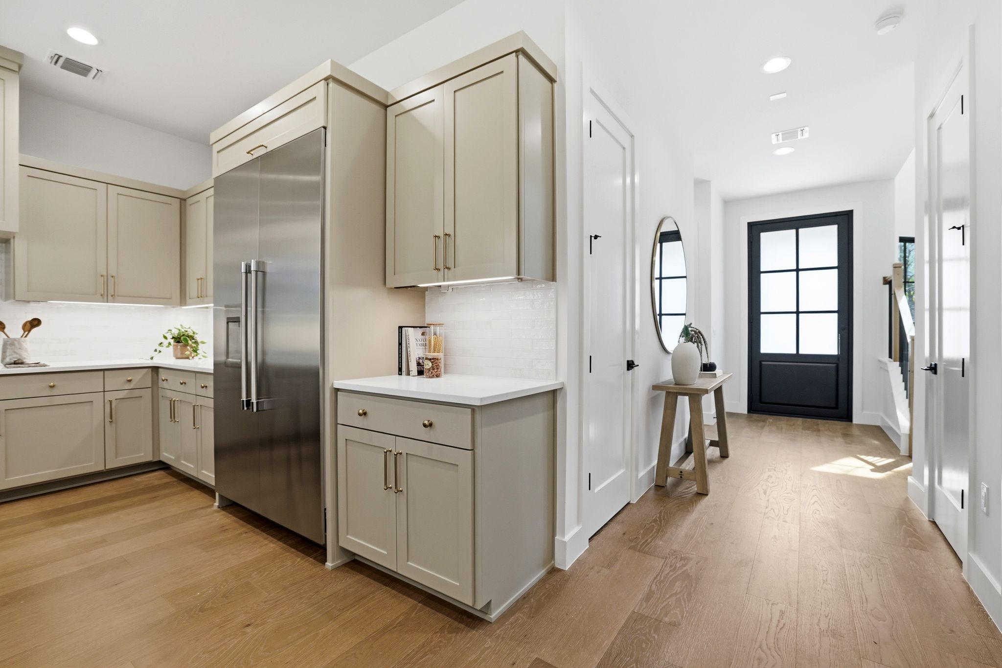 4500 Jinx Avenue Austin, TX 78745 - Photo 11 of 40 Kitchen featuring built in fridge, light wood-type flooring, recessed lighting, cream cabinets, and gray cabinetry