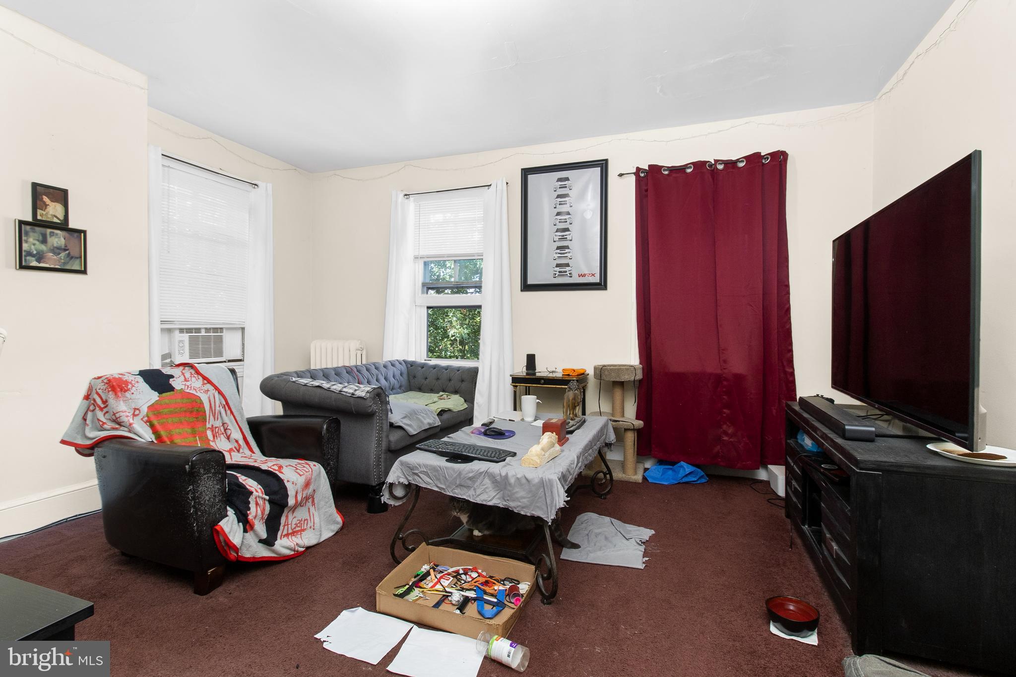 85 Madison Avenue Mount Holly, NJ 08060 - Photo 37 of 41 a living room with furniture a flat screen tv and a window