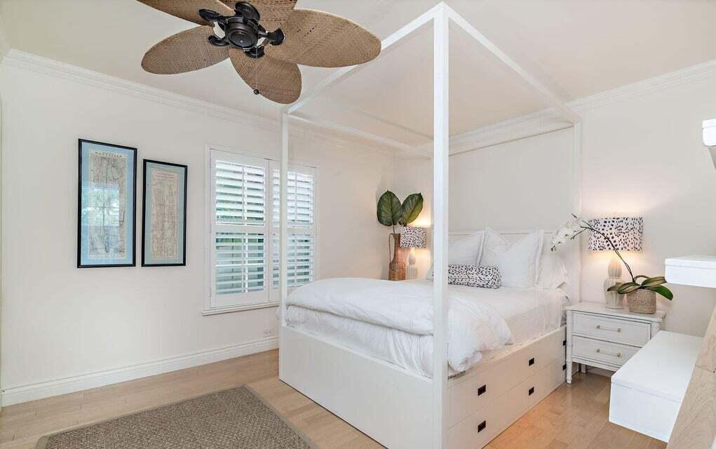 156 Peruvian Avenue Palm Beach, FL 33480 - Photo 12 of 20 a bedroom with a bed and a chandelier