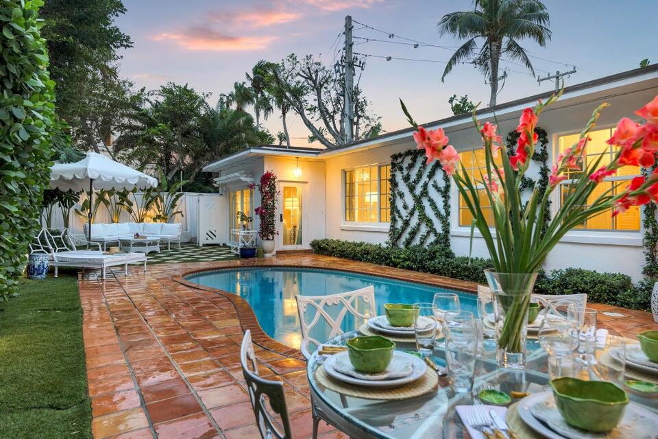 156 Peruvian Avenue Palm Beach, FL 33480 - Photo 15 of 20 a view of a swimming pool with potted plants and a large tree