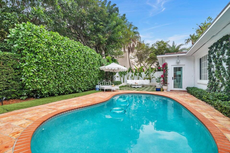 156 Peruvian Avenue Palm Beach, FL 33480 - Photo 16 of 20 a view of a swimming pool with a yard