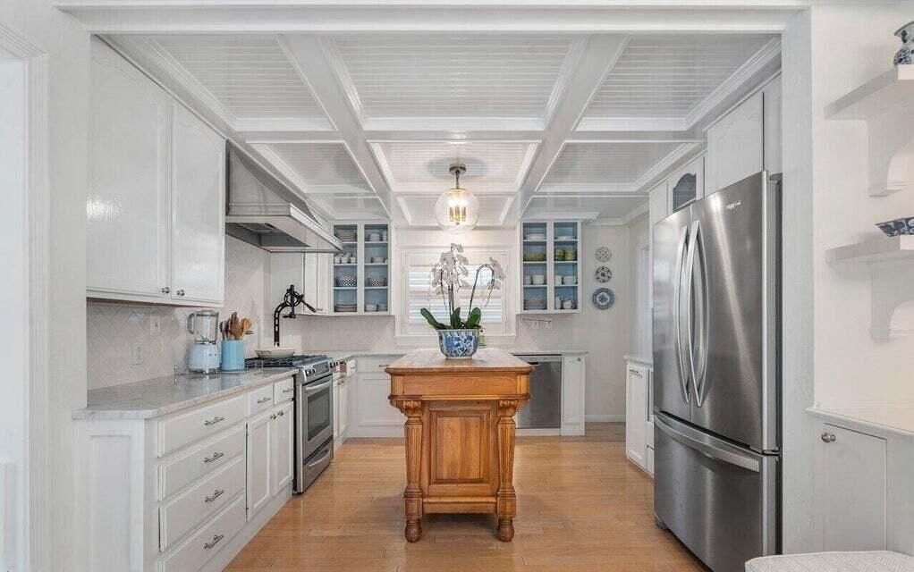 156 Peruvian Avenue Palm Beach, FL 33480 - Photo 8 of 20 a kitchen with stainless steel appliances granite countertop a refrigerator a sink dishwasher a stove and white cabinets with wooden floor