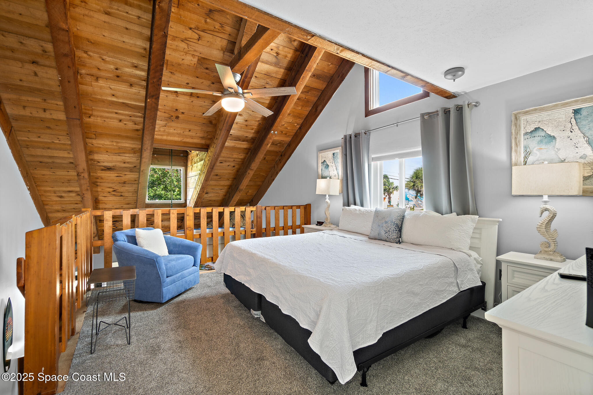 8156 Ridgewood Avenue Cape Canaveral, FL 32920 - Photo 11 of 53 a bedroom with a bed couch and a window