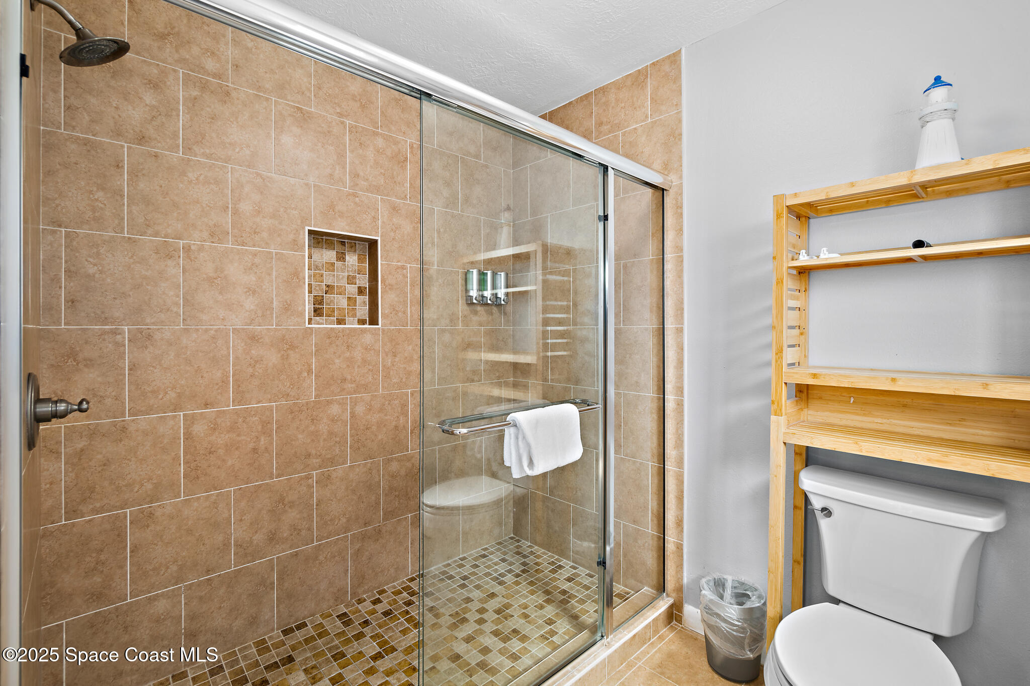 8156 Ridgewood Avenue Cape Canaveral, FL 32920 - Photo 12 of 53 a bathroom with a toilet and a shower