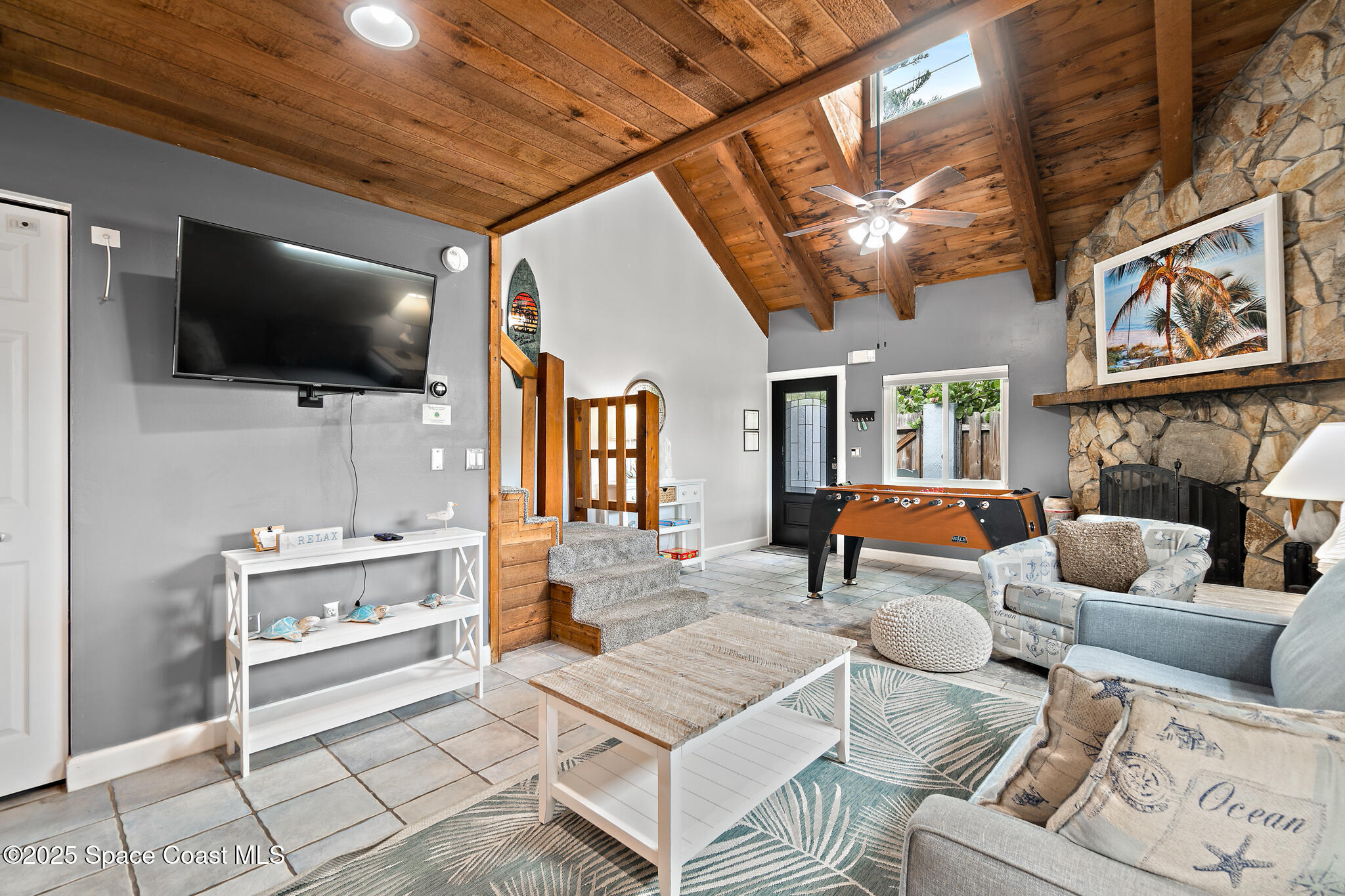 8156 Ridgewood Avenue Cape Canaveral, FL 32920 - Photo 22 of 53 a living room with furniture and a flat screen tv