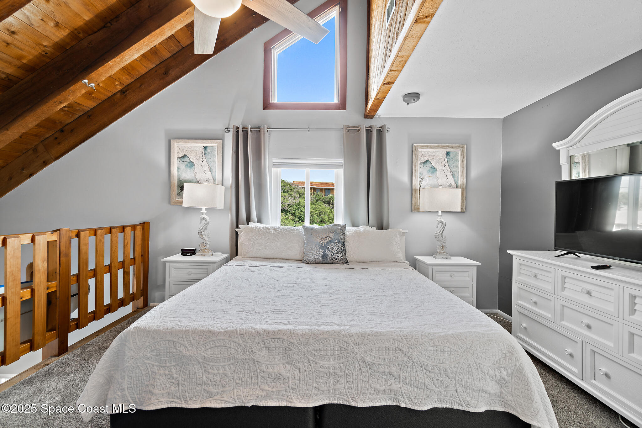 8156 Ridgewood Avenue Cape Canaveral, FL 32920 - Photo 27 of 53 a bedroom with a bed and a flat screen tv