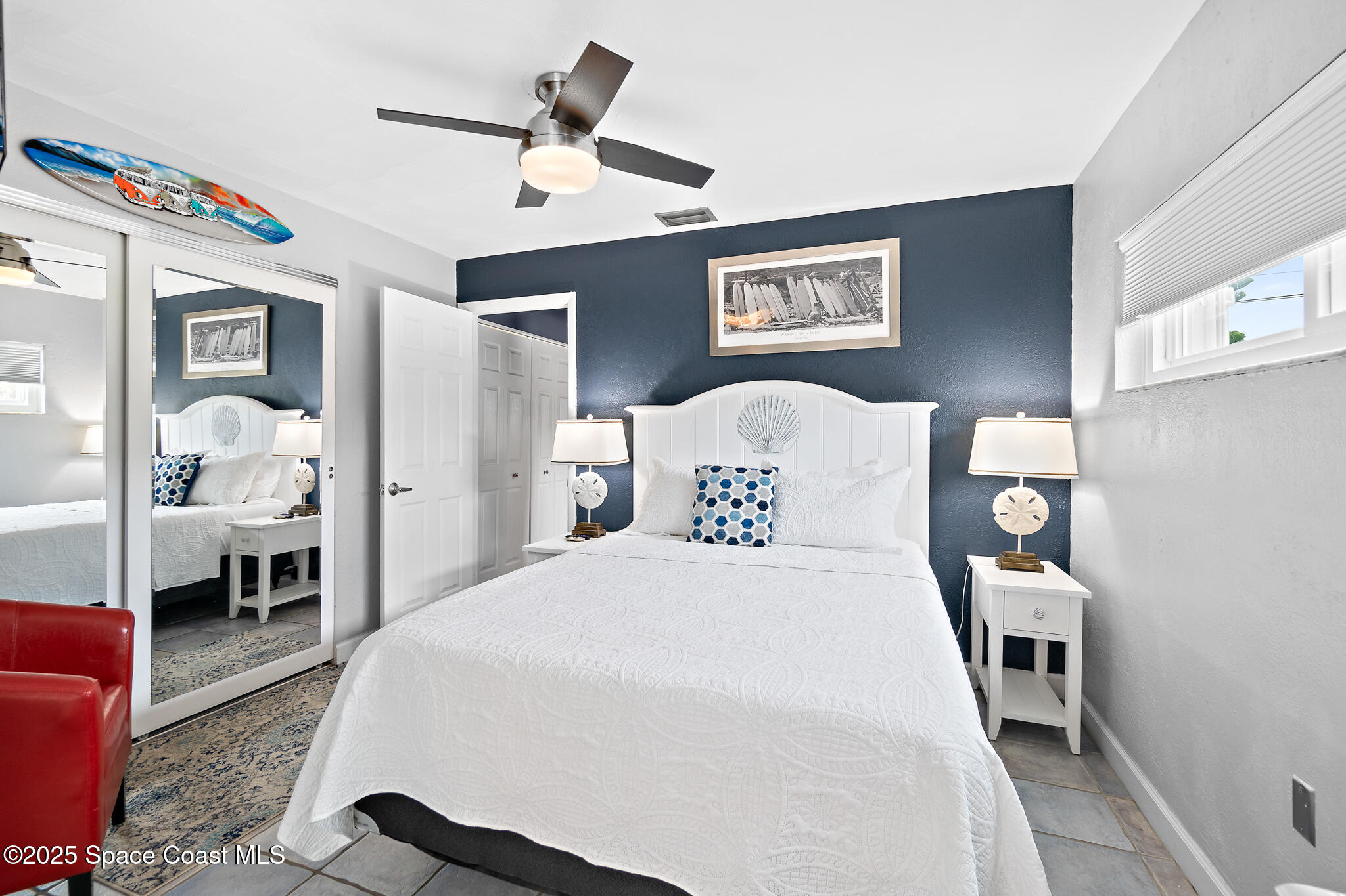 8156 Ridgewood Avenue Cape Canaveral, FL 32920 - Photo 34 of 53 a bedroom with a bed and a table in it