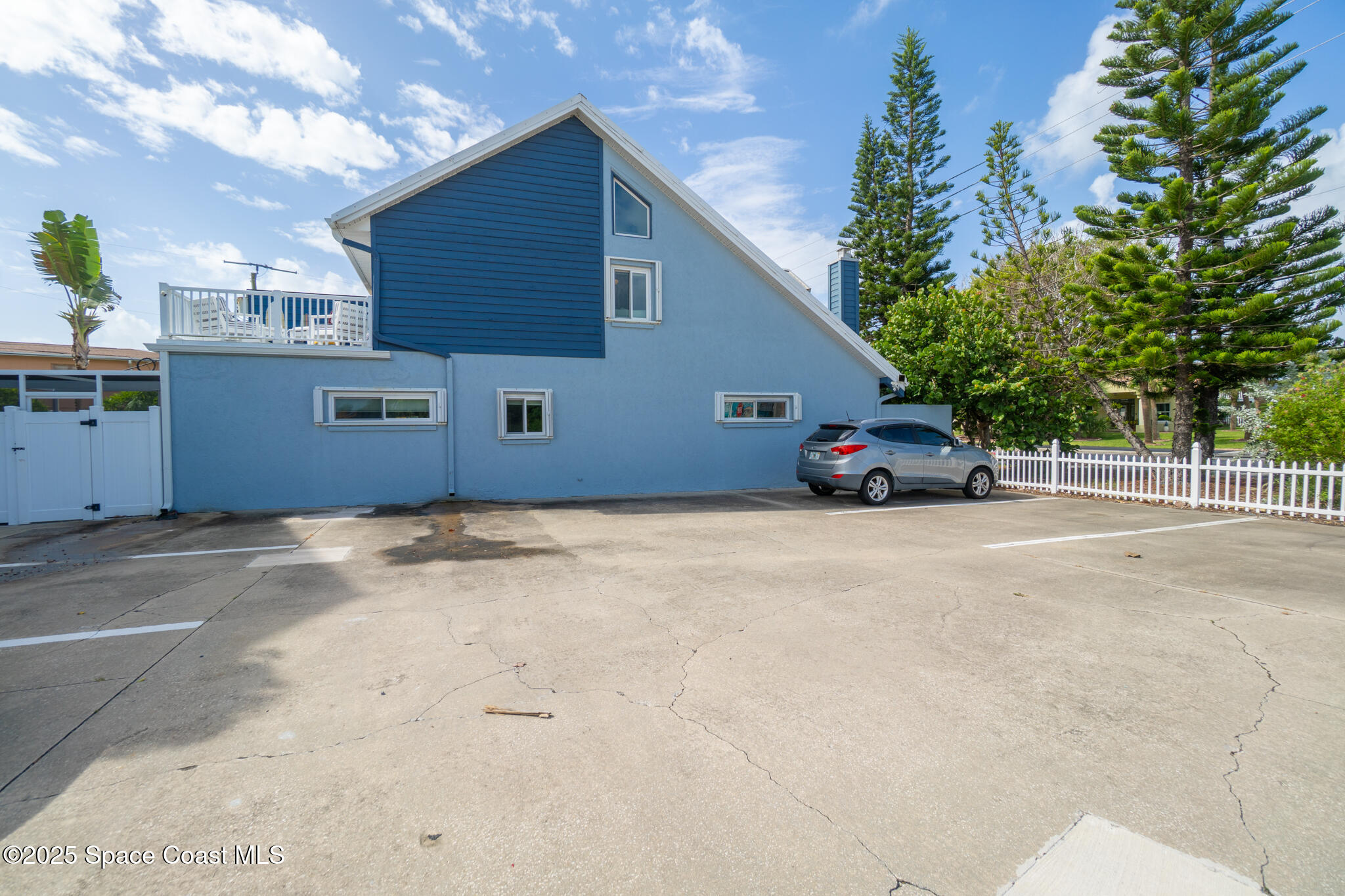 8156 Ridgewood Avenue Cape Canaveral, FL 32920 - Photo 40 of 53 a car parked in front of a house