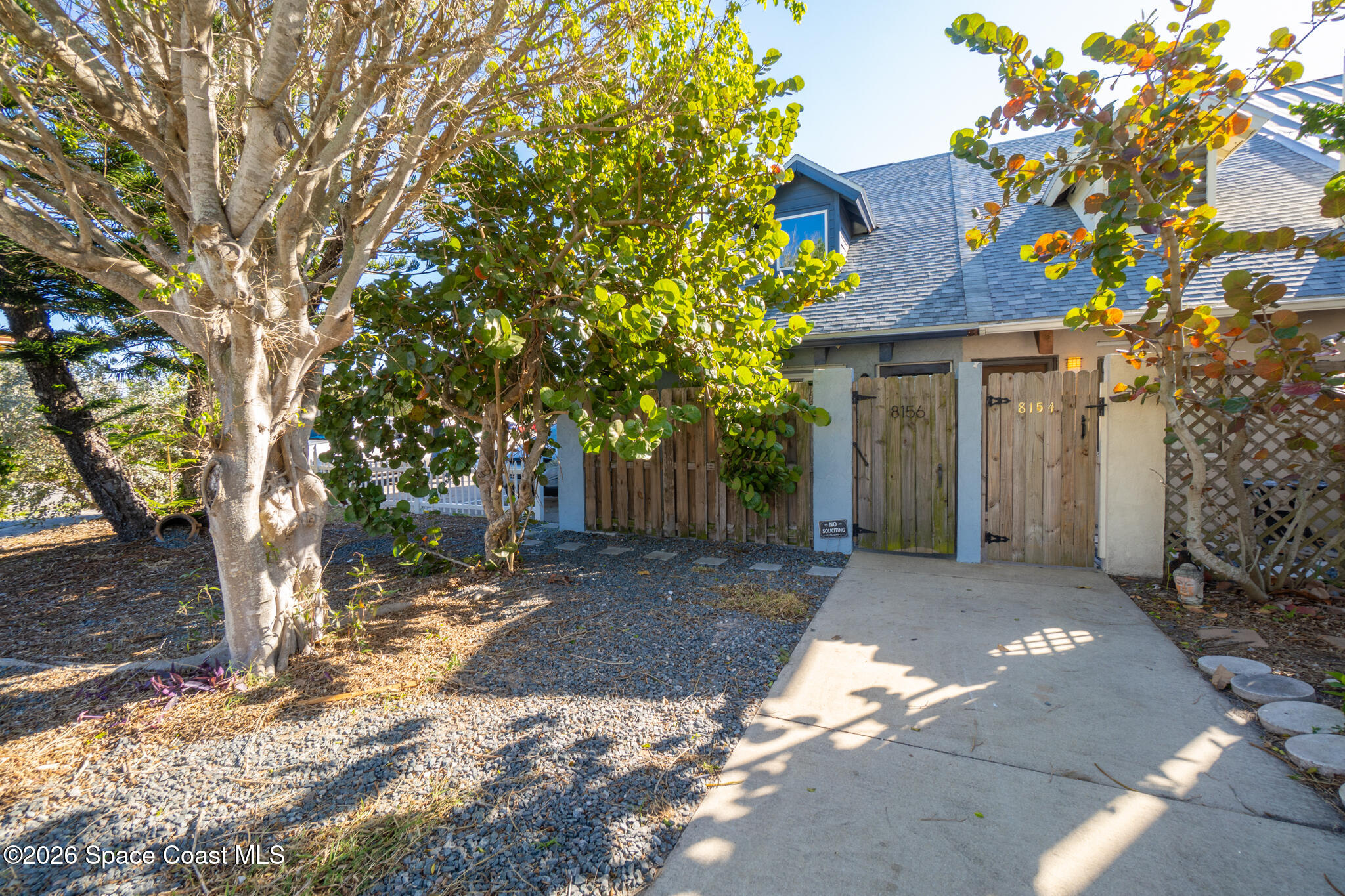 8156 Ridgewood Avenue Cape Canaveral, FL 32920 - Photo 41 of 53 a front view of a house with a yard