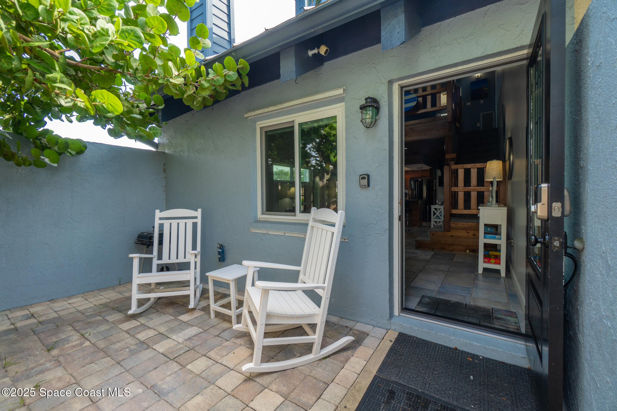 8156 Ridgewood Avenue Cape Canaveral, FL 32920 - Photo 42 of 53 a chairs and a table in a balcony