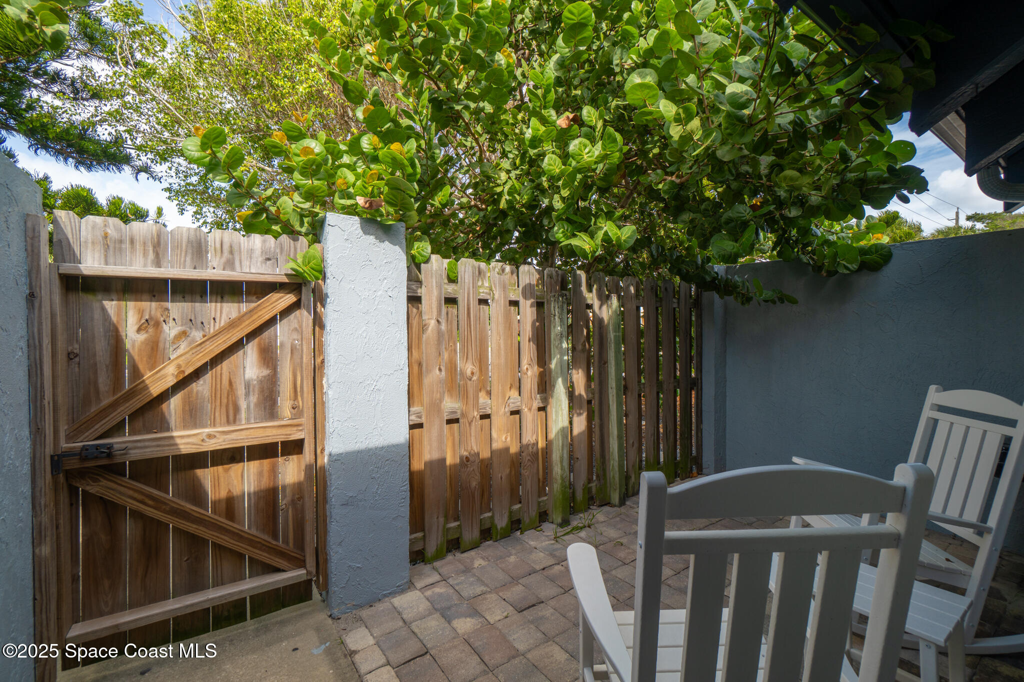 8156 Ridgewood Avenue Cape Canaveral, FL 32920 - Photo 43 of 53 a view of deck with furniture and trees