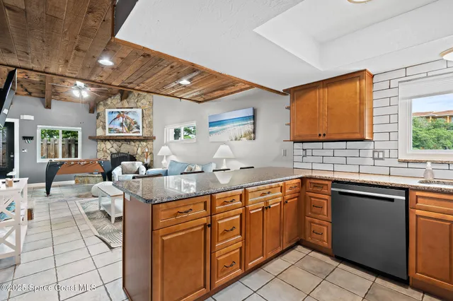 a bedroom with a bed a flat screen tv and dresser