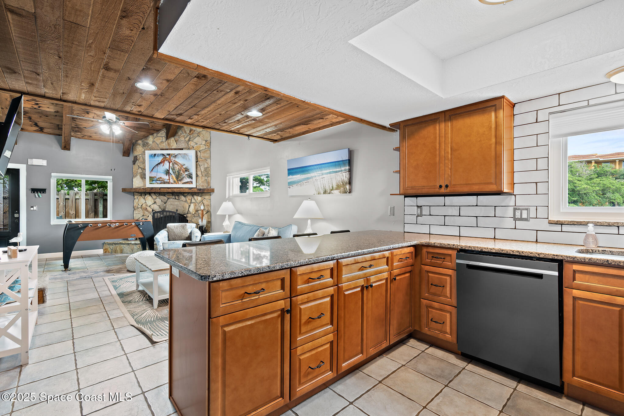 8156 Ridgewood Avenue Cape Canaveral, FL 32920 - Photo 6 of 53 a kitchen with stainless steel appliances granite countertop a sink and cabinets