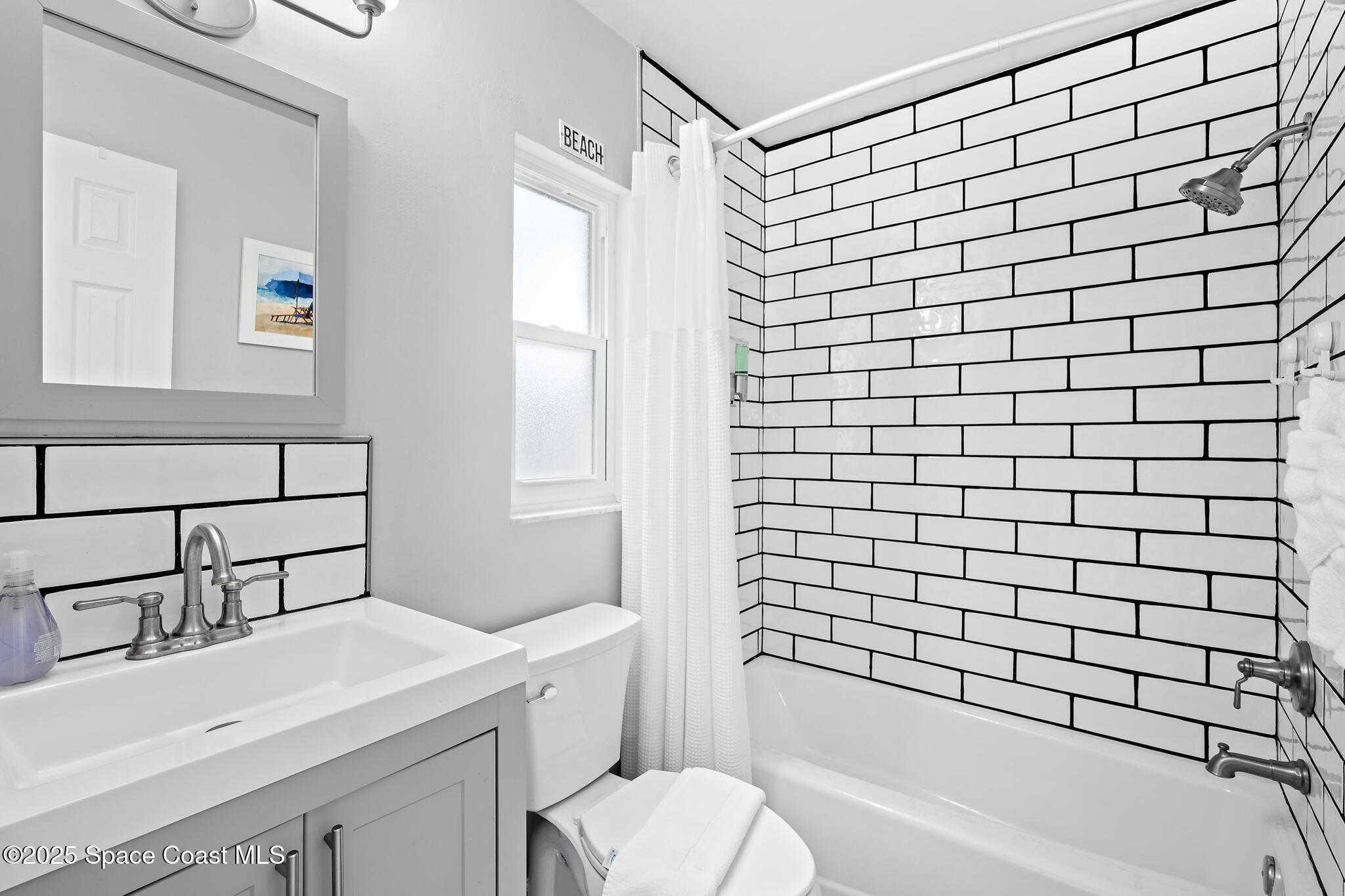 8156 Ridgewood Avenue Cape Canaveral, FL 32920 - Photo 8 of 53 a bathroom with a sink a toilet and shower