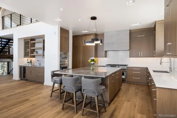 a kitchen with a table chairs sink and cabinets