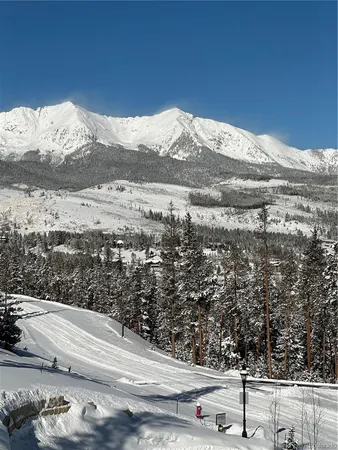 a view of a building with mountains in the background