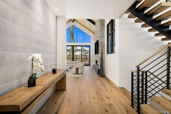 a very nice looking room with wooden floor and furniture