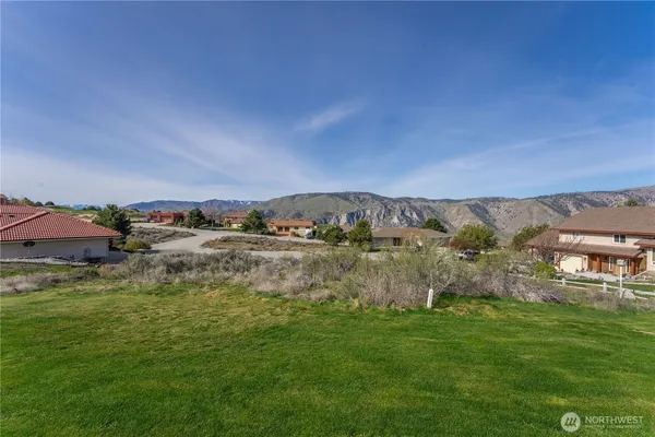 a view of a lake with houses in the back
