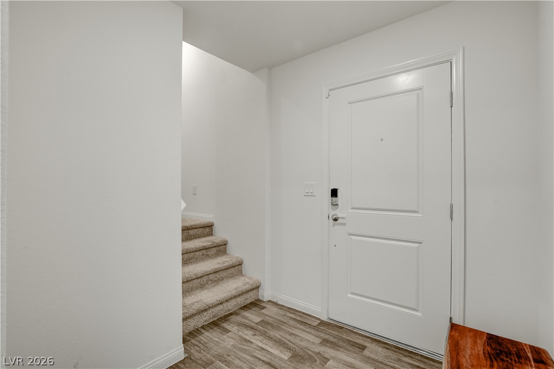 6924 Spicy Merlot Street North Las Vegas, NV 89086 - Photo 21 of 83 A welcoming entryway offers durable wood-look flooring and convenient stair access to upper levels.