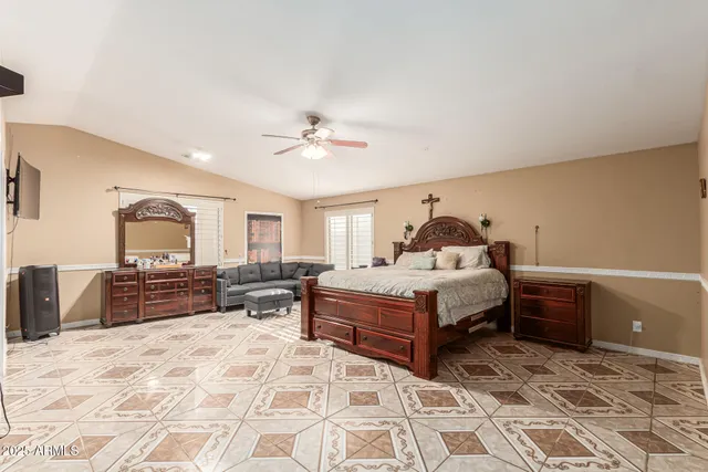 a spacious bedroom with a bed and dresser