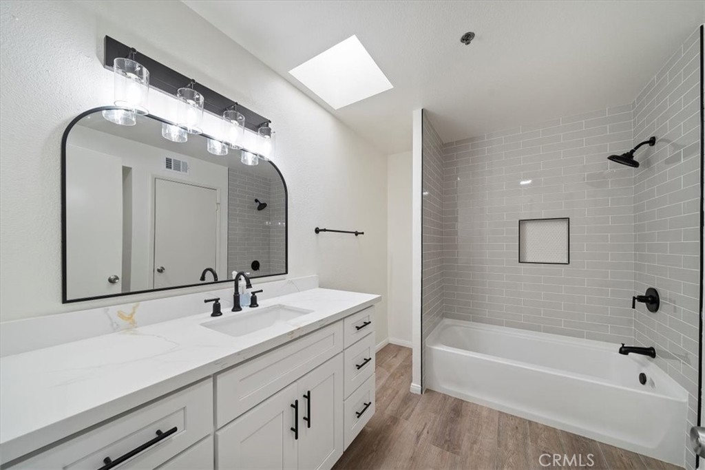 200 East Racquet Club Road, Unit 72 Palm Springs, CA 92262 - Photo 11 of 19 a bathroom with a tub a double vanity sink and mirror