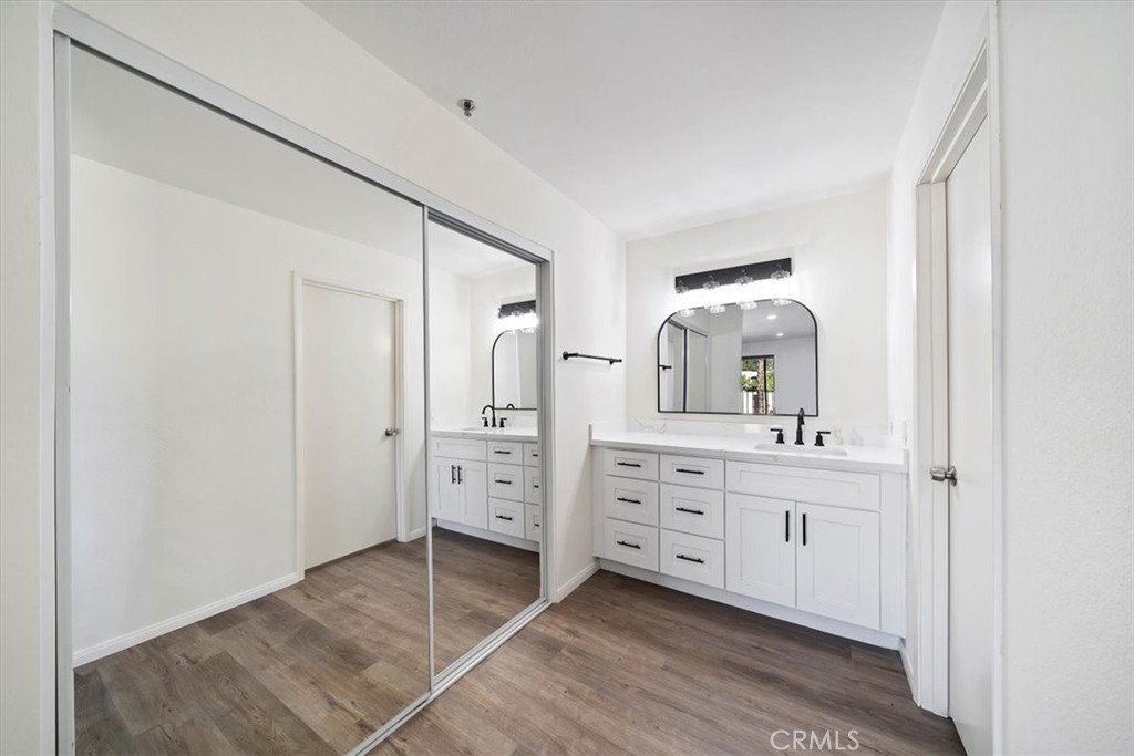 200 East Racquet Club Road, Unit 72 Palm Springs, CA 92262 - Photo 12 of 19 a spacious bathroom with a double vanity sink and mirror