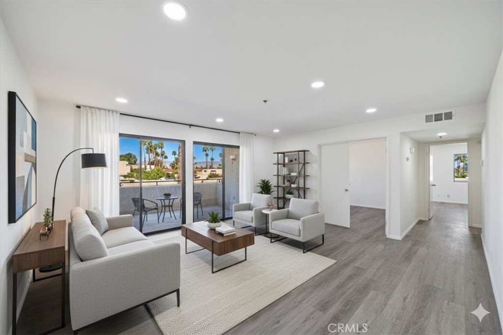 200 East Racquet Club Road, Unit 72 Palm Springs, CA 92262 - Photo 4 of 19 a living room with furniture and a large window