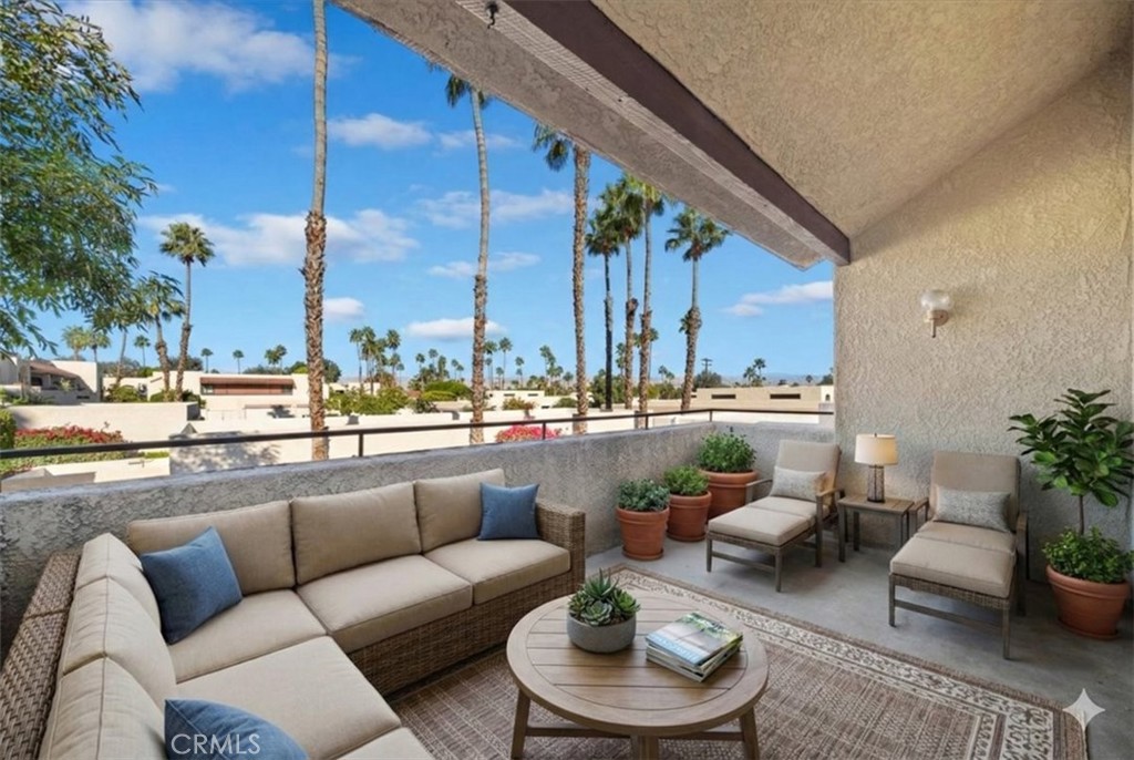 200 East Racquet Club Road, Unit 72 Palm Springs, CA 92262 - Photo 5 of 19 a balcony with furniture and a large tree
