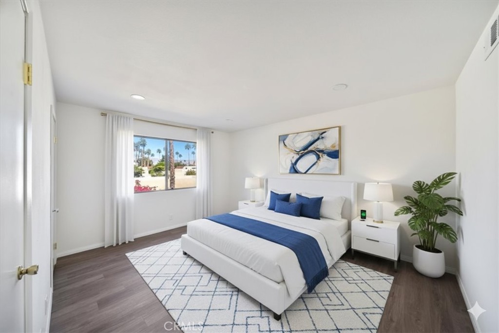 200 East Racquet Club Road, Unit 72 Palm Springs, CA 92262 - Photo 8 of 19 a bedroom with a bed and potted plant