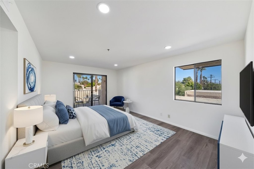 200 East Racquet Club Road, Unit 72 Palm Springs, CA 92262 - Photo 10 of 19 a bedroom with a large bed and a window