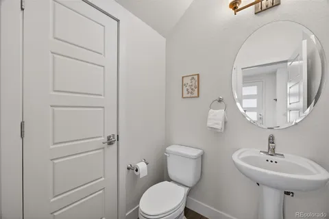 a bathroom with a granite countertop sink a mirror and a shower