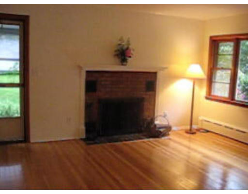 574 Ryan Road Northampton, MA 01062 - Photo 4 of 7 a view of empty room with wooden floor and fireplace