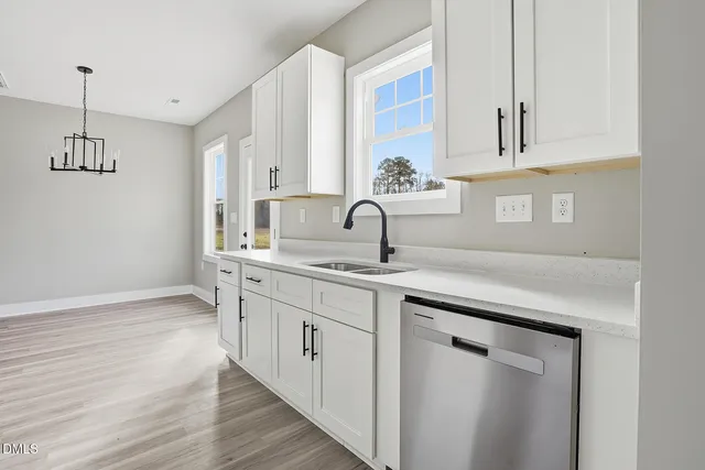 a kitchen with sink and cabinets