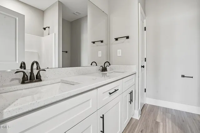 a bathroom with a double vanity sink and mirror