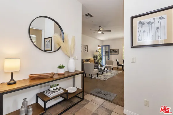 a living room with furniture a rug and a window