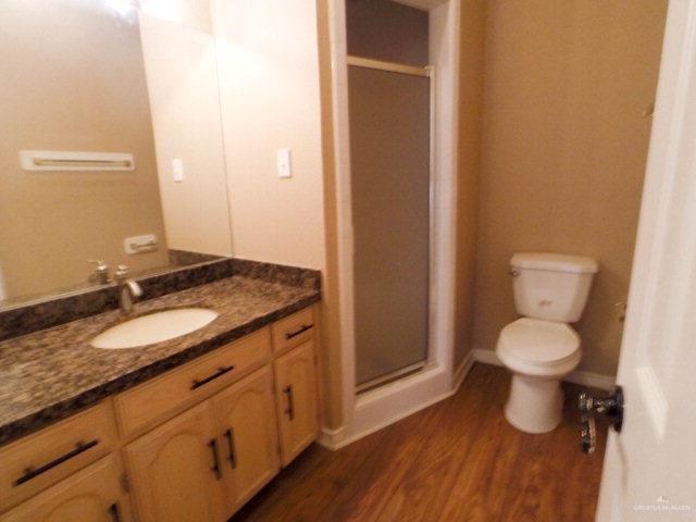 204 San Saba Street Mission, TX 78572 - Photo 12 of 15 a bathroom with a granite countertop toilet and a sink