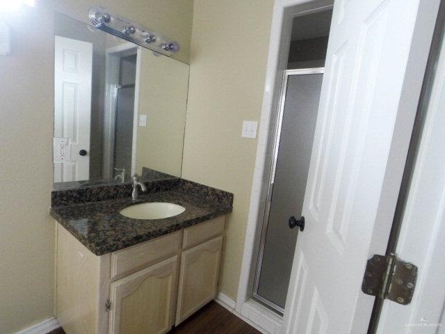 204 San Saba Street Mission, TX 78572 - Photo 13 of 15 a bathroom with a granite countertop sink and a mirror