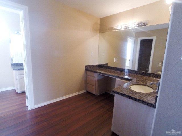 204 San Saba Street Mission, TX 78572 - Photo 14 of 15 a bathroom with a granite countertop sink and a mirror