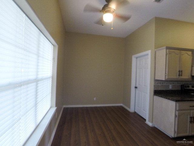 204 San Saba Street Mission, TX 78572 - Photo 7 of 15 a view of a kitchen with a fridge and wooden floor