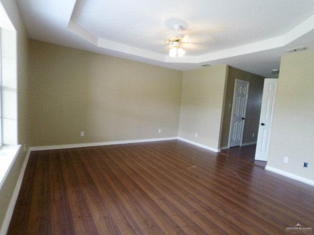 204 San Saba Street Mission, TX 78572 - Photo 8 of 15 an empty room with wooden floor and chandelier fan