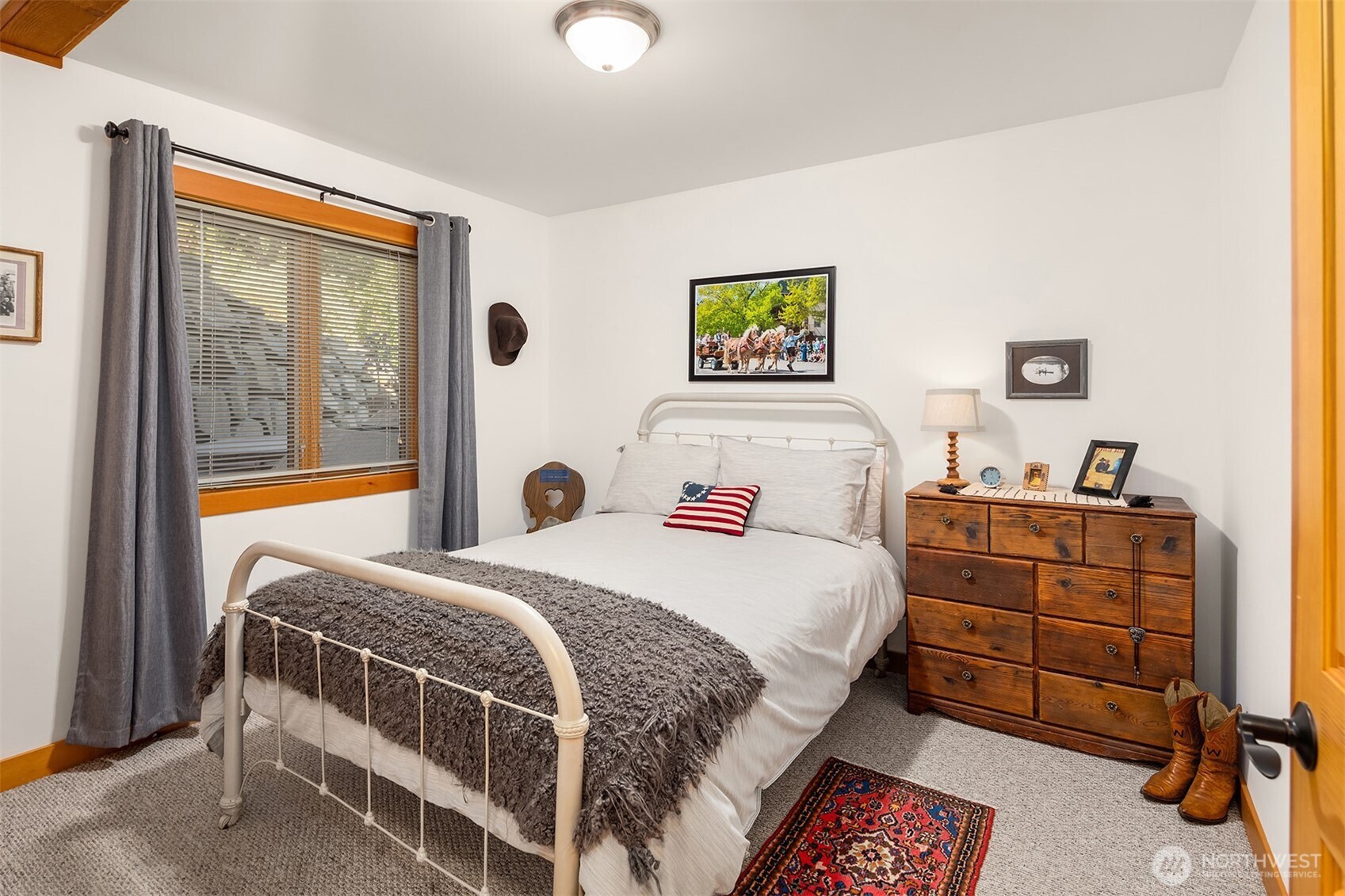 951 Willems Road Cashmere, WA 98815 - Photo 23 of 40 a bedroom with a bed and a dresser next to a window